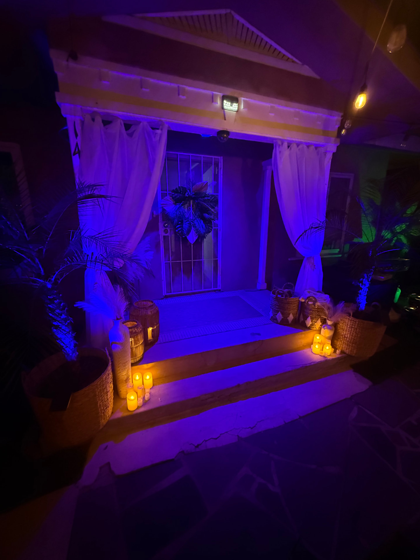 Casa Tulum entrance lit with candles and tropical blue lighting